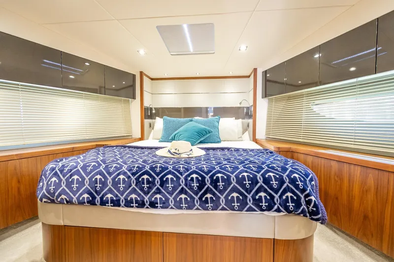 Slide: The Image of Luxurious bedroom interior of 2018 Sunseeker Predator 57 yacht with nautical-themed decor. - 78