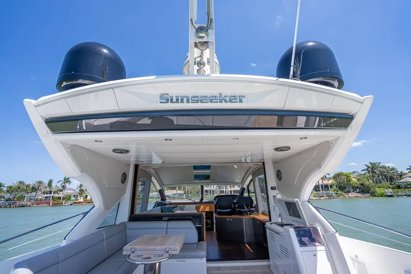 Slide: The Image of 2018 Sunseeker Predator 57 yacht, luxurious deck view, sunny waterfront setting. - 43