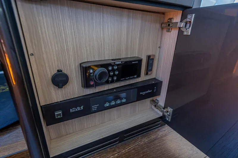 Slide: The Image of Control panel inside a 2018 Sunseeker Predator 57 yacht, featuring Fusion and TracVision systems. - 66
