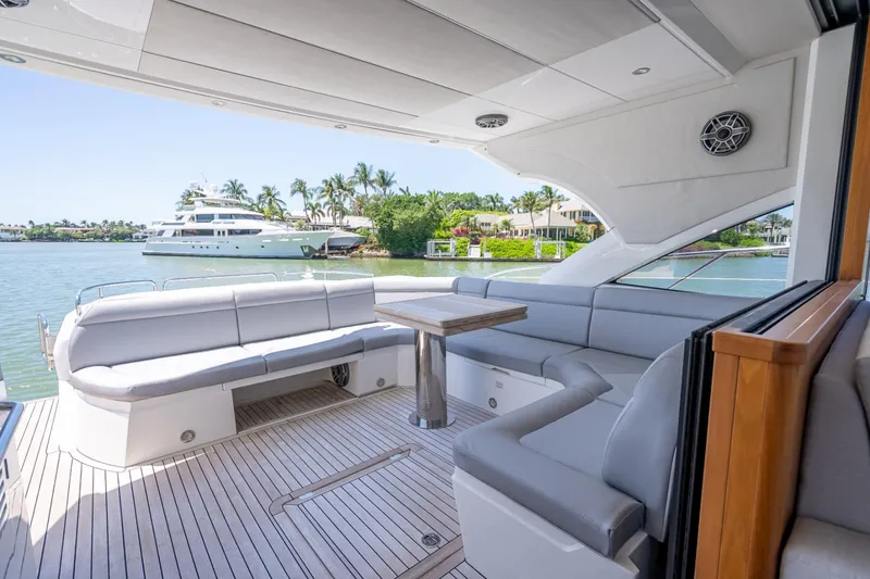 Slide: The Image of Luxurious 2018 Sunseeker Predator 57 yacht interior with elegant seating and scenic waterfront view. - 35