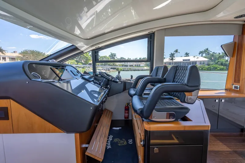 Slide: The Image of Interior helm of 2018 Sunseeker Predator 57 yacht with luxurious seating and control panel. - 59