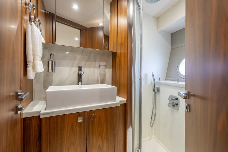 Slide: The Image of Luxurious bathroom in 2018 Sunseeker Predator 57 yacht with modern fixtures and wood accents. - 81