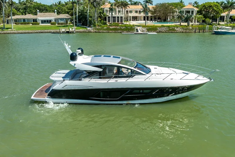Slide: The Image of 2018 Sunseeker Predator 57 yacht cruising on a serene waterway. - 17