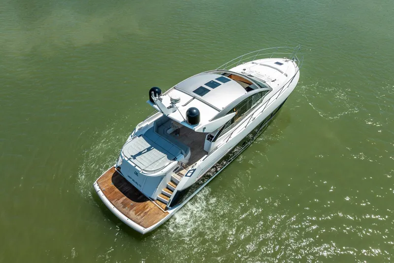 Slide: The Image of 2018 Sunseeker Predator 57 yacht cruising on calm green waters. - 19