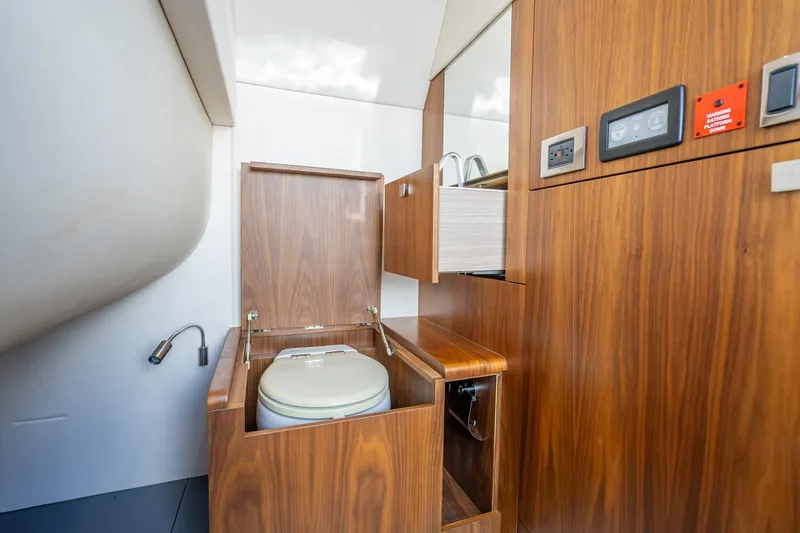 Slide: The Image of 2018 Sunseeker Predator 57 yacht bathroom with wooden cabinetry and modern fixtures. - 74
