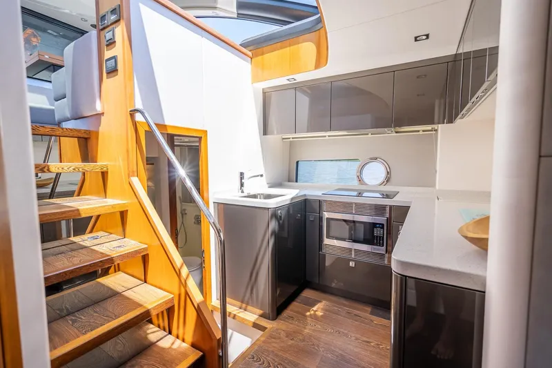 Slide: The Image of Luxurious interior of 2018 Sunseeker Predator 57 yacht with modern kitchen and wooden stairs. - 49