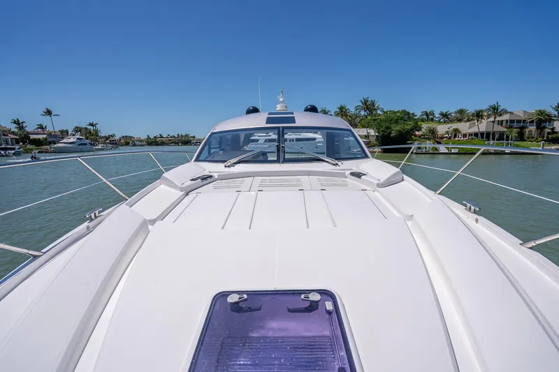 Slide: The Image of 2018 Sunseeker Predator 57 yacht on calm waters, showcasing sleek design and luxury features. - 31