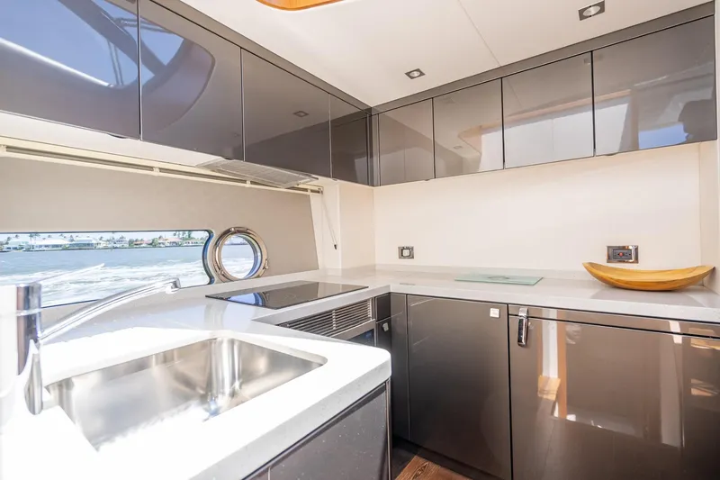 Slide: The Image of Modern kitchen interior of 2018 Sunseeker Predator 57 yacht with sleek cabinetry and ocean view. - 50