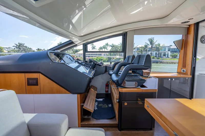 Slide: The Image of Interior of 2018 Sunseeker Predator 57 yacht, featuring modern helm and luxurious seating. - 65
