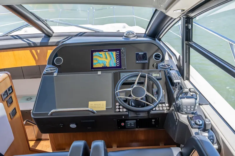 Slide: The Image of Cockpit of 2018 Sunseeker Predator 57 yacht with navigation equipment and steering wheel. - 64