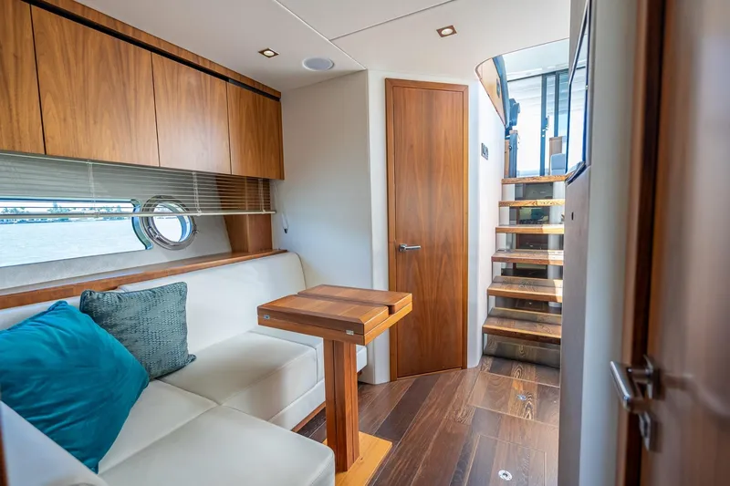 Slide: The Image of Luxurious interior of 2018 Sunseeker Predator 57 yacht with wooden accents and cozy seating. - 72