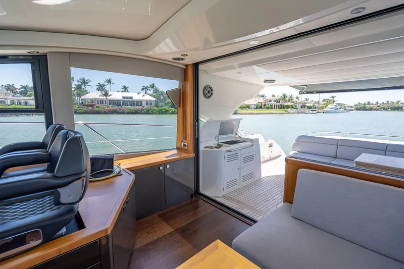 Slide: The Image of Interior view of 2018 Sunseeker Predator 57 yacht with open deck and waterfront scenery. - 45