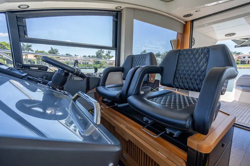 Slide: The Image of Luxurious 2018 Sunseeker Predator 57 yacht interior with leather seating and modern helm. - 58