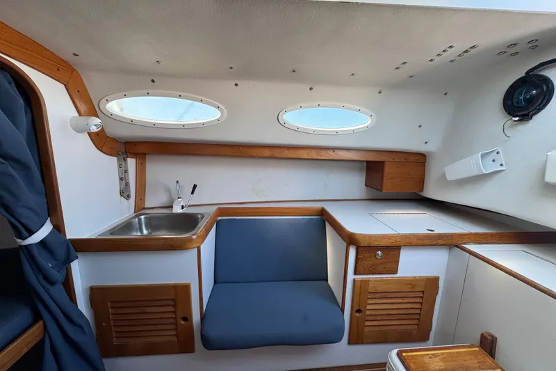 Slide: The Image of Interior of a 2000 Alerion Express 28 sailboat with wood accents and compact seating. - 12