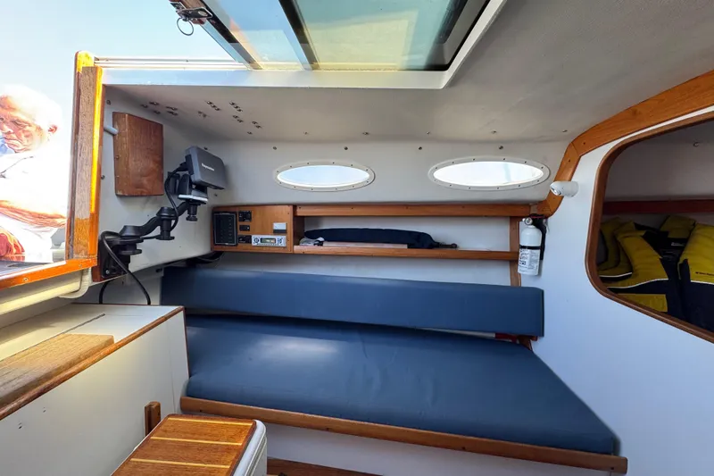 Slide: The Image of Interior of a 2000 Alerion Express 28 sailboat with seating and navigation equipment. - 13