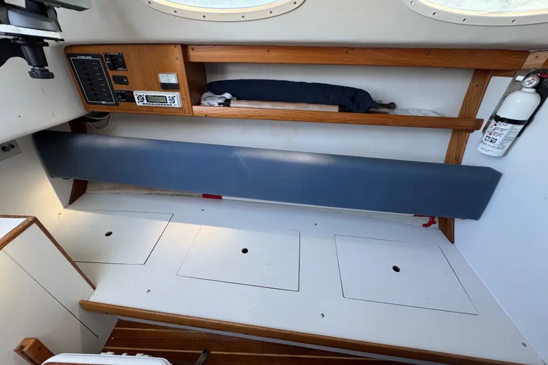 Slide: The Image of Interior of a 2000 Alerion Express 28 sailboat with control panel and storage. - 14