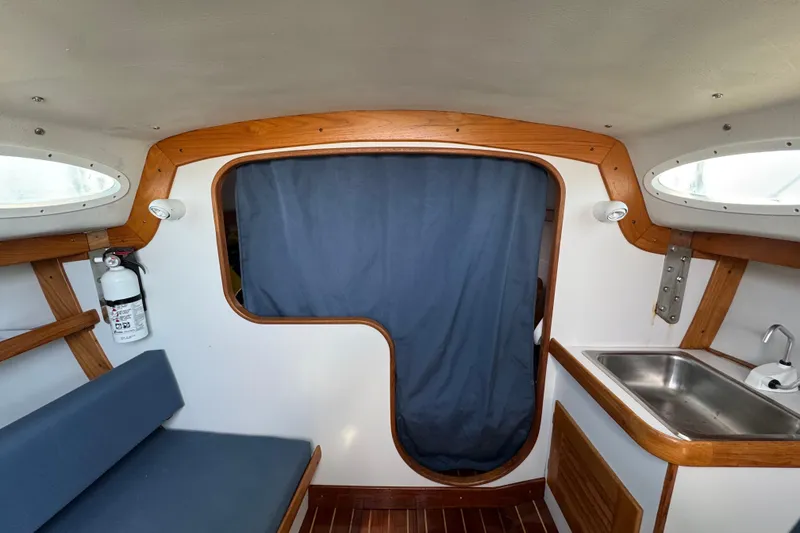 Slide: The Image of Interior of a 2000 Alerion Express 28 sailboat, featuring a cozy cabin with wood accents. - 17