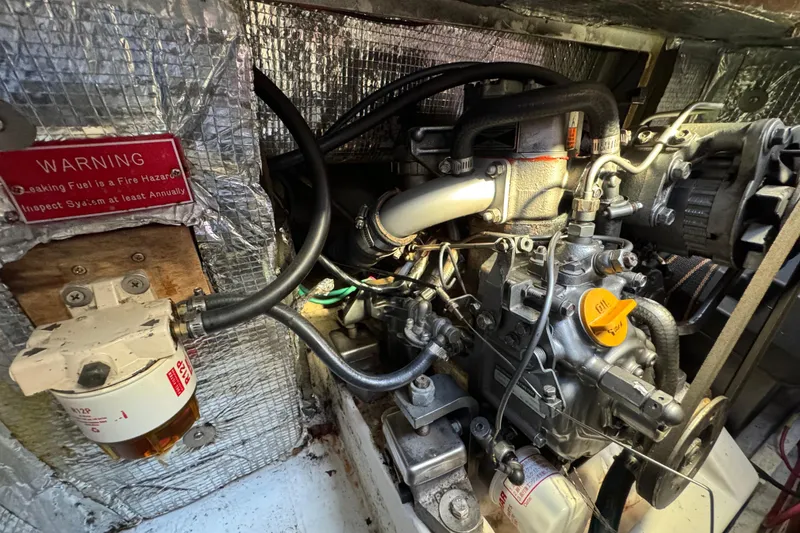 Slide: The Image of Engine compartment of a 2000 Alerion Express 28 sailboat, showing detailed mechanical components. - 20