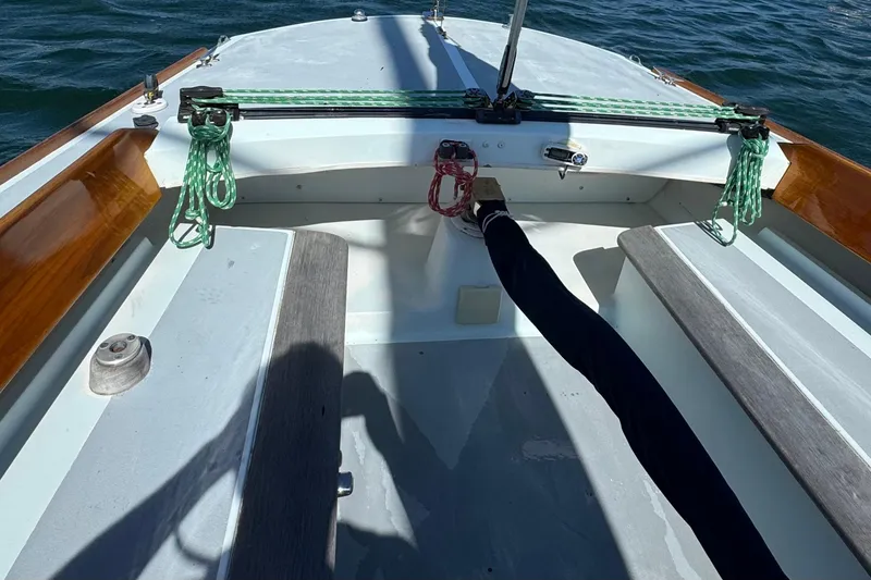 Slide: The Image of Cockpit of a 2000 Alerion Express 28 sailboat with wooden trim and green ropes. - 9