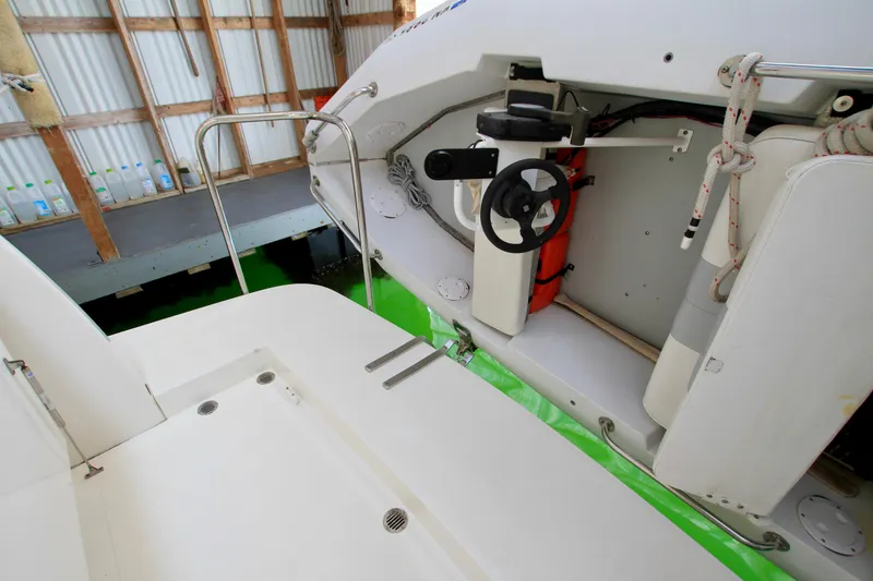 Slide: The Image of 2011 Fathom Element 43 boat interior with steering wheel and safety equipment. - 10