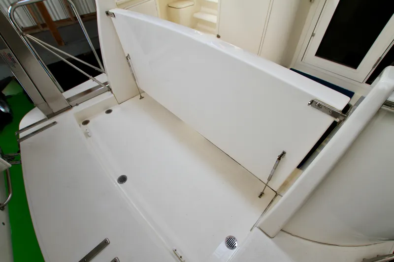 Slide: The Image of 2011 Fathom Element 43 boat deck with foldable seating and stainless steel railings. - 11