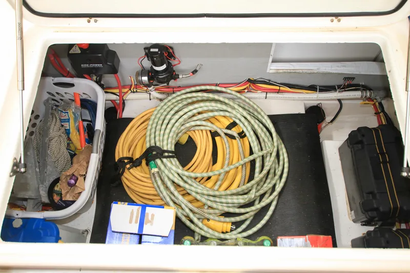 Slide: The Image of Storage compartment of 2011 Fathom Element 43 with hoses, cables, and supplies. - 13