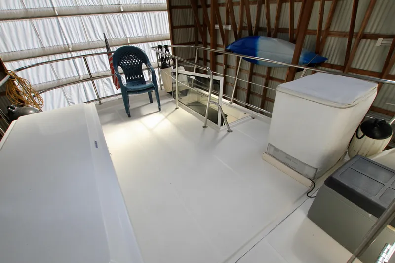 Slide: The Image of Rooftop deck of 2011 Fathom Element 43 boat with chair and storage. - 15