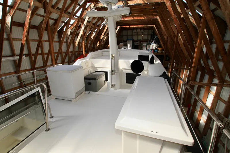 Slide: The Image of 2011 Fathom Element 43 yacht interior in wooden boathouse, showcasing sleek design. - 16