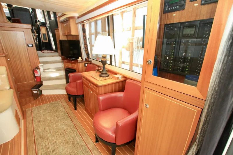 Slide: The Image of Luxurious interior of 2011 Fathom Element 43 yacht with wood paneling and red leather chairs. - 24