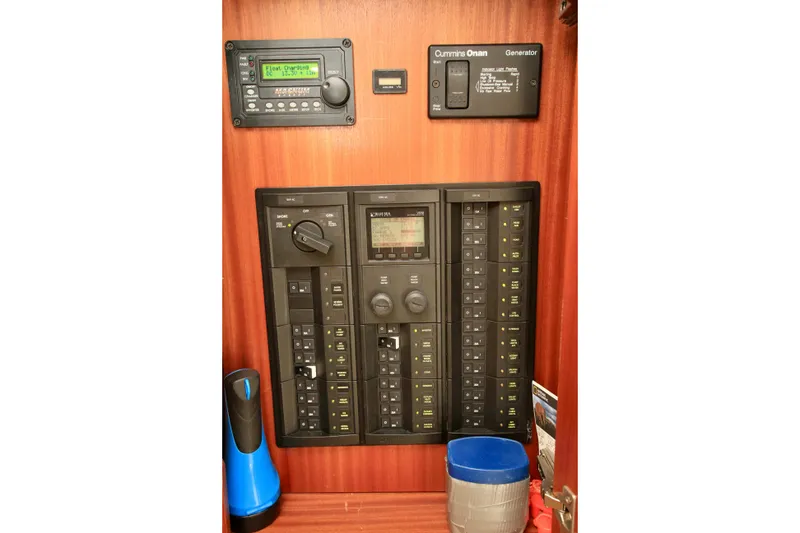 Slide: The Image of Electrical control panel on a 2011 Fathom Element 43 boat, featuring Cummins Onan generator. - 25