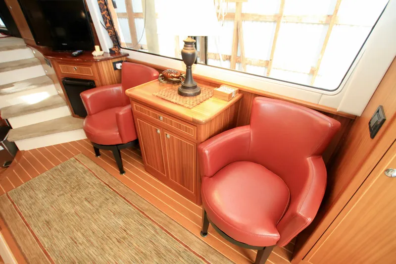 Slide: The Image of Luxurious interior of 2011 Fathom Element 43 yacht with red leather chairs and wooden cabinetry. - 26