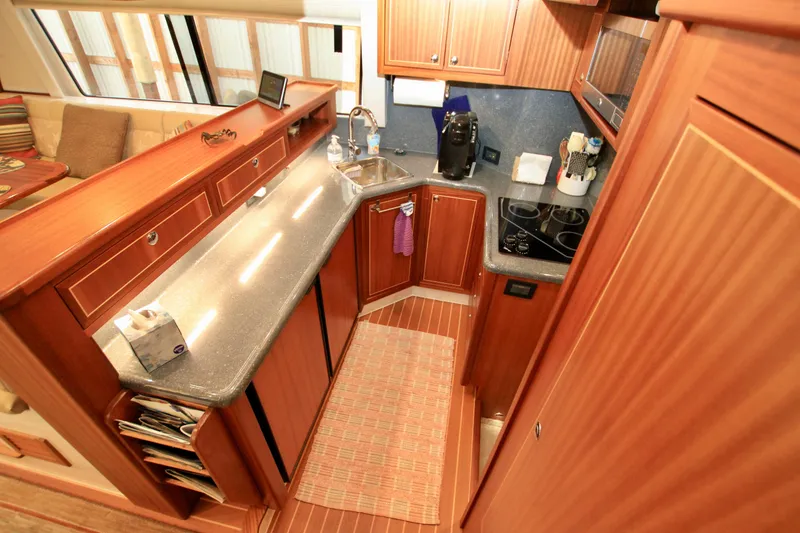 Slide: The Image of Luxurious 2011 Fathom Element 43 yacht kitchen with wood cabinetry and modern appliances. - 29