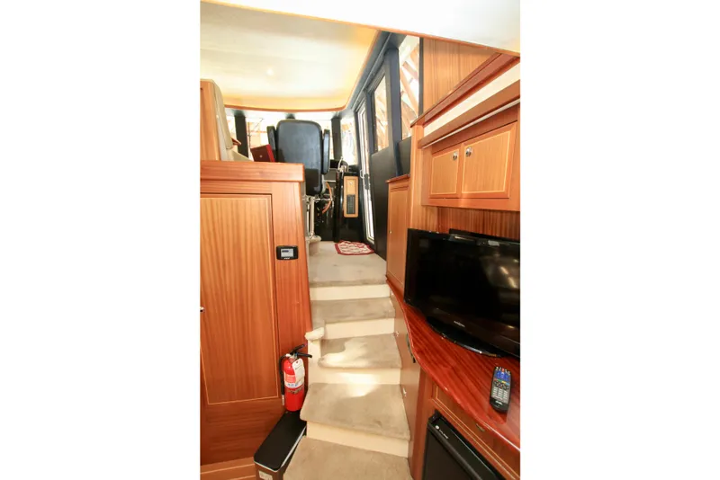 Slide: The Image of Interior of 2011 Fathom Element 43 yacht with stairs, TV, and wooden cabinetry. - 33