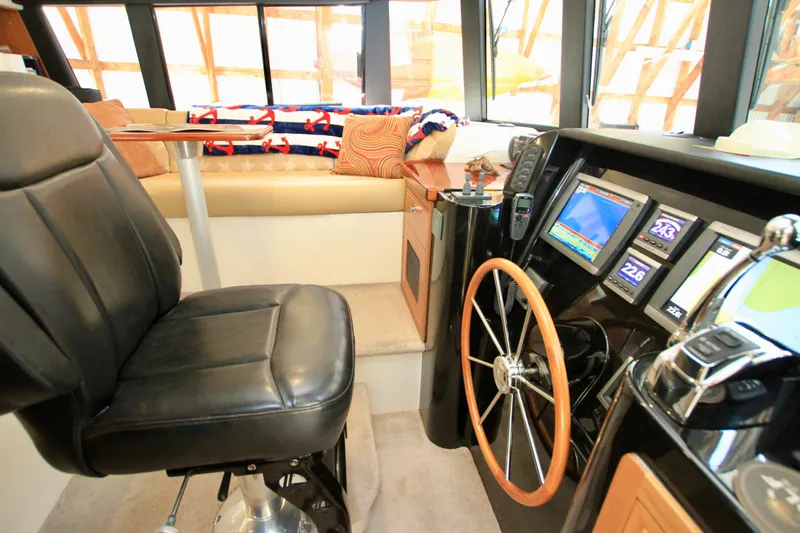 Slide: The Image of Interior of 2011 Fathom Element 43 yacht with helm, leather seat, and navigation screens. - 35