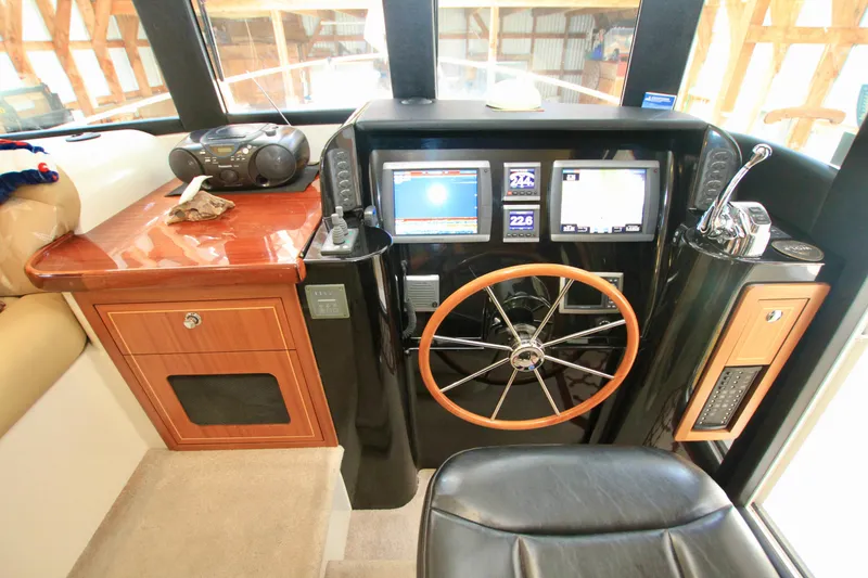 Slide: The Image of 2011 Fathom Element 43 yacht helm with navigation screens and wooden steering wheel. - 39