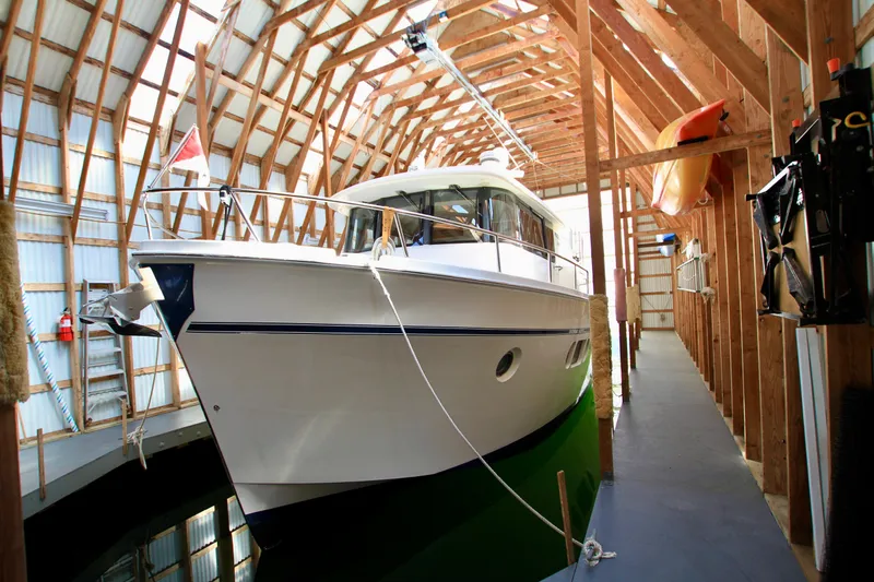 Slide: The Image of 2011 Fathom Element 43 yacht docked in a wooden boathouse. - 4