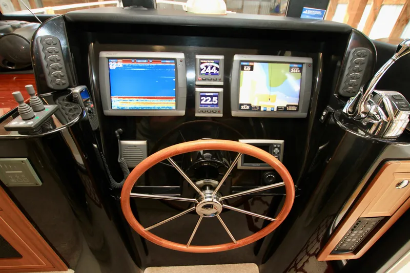 Slide: The Image of Helm of 2011 Fathom Element 43 with navigation screens and wooden steering wheel. - 40