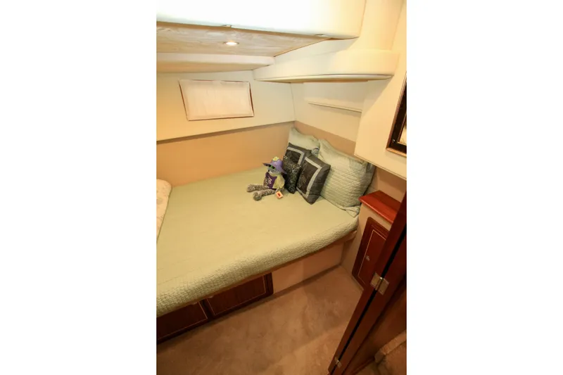 Slide: The Image of Cozy bedroom in 2011 Fathom Element 43 yacht with plush bedding and decorative pillows. - 48