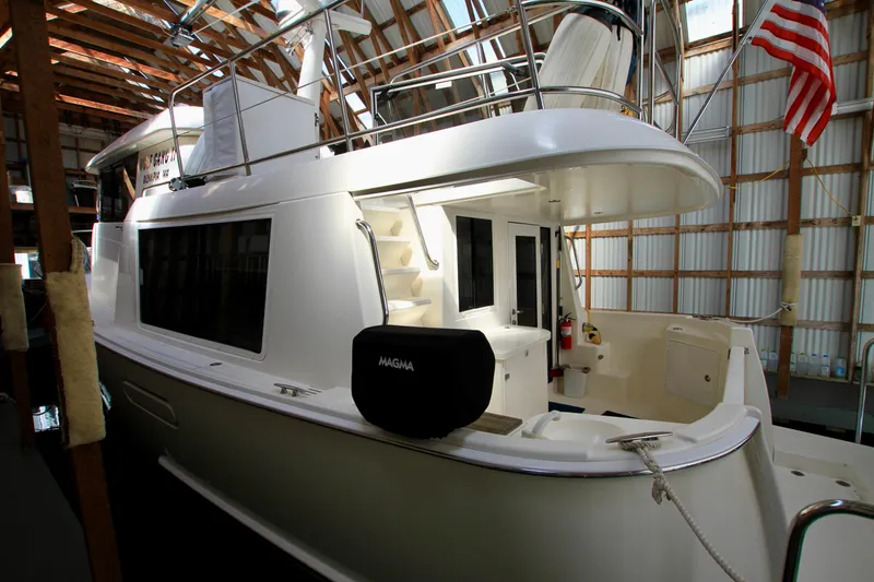Slide: The Image of 2011 Fathom Element 43 yacht docked indoors with American flag. - 5