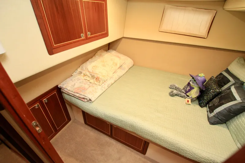 Slide: The Image of Cozy cabin interior of 2011 Fathom Element 43 with bed and decorative pillows. - 51