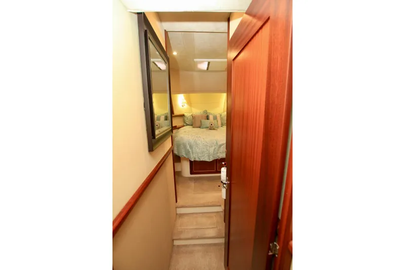 Slide: The Image of Cozy cabin interior of 2011 Fathom Element 43 yacht with bed and wooden accents. - 53