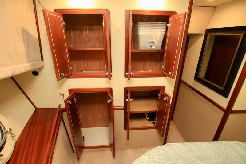 Slide: The Image of Wooden cabinets in a 2011 Fathom Element 43 interior, showcasing ample storage space. - 57