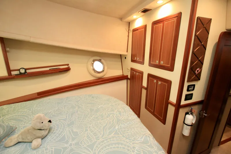 Slide: The Image of Cozy cabin interior of 2011 Fathom Element 43 yacht with porthole and plush decor. - 59