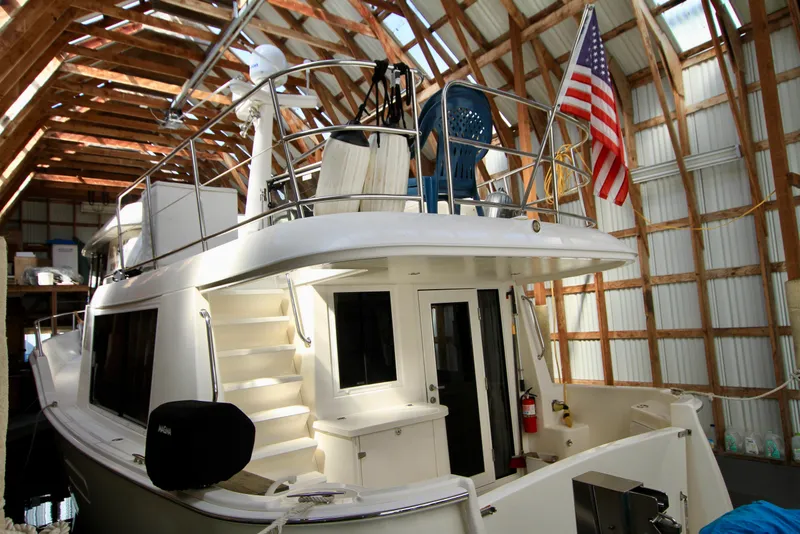 Slide: The Image of 2011 Fathom Element 43 yacht in a boathouse with American flag displayed. - 6