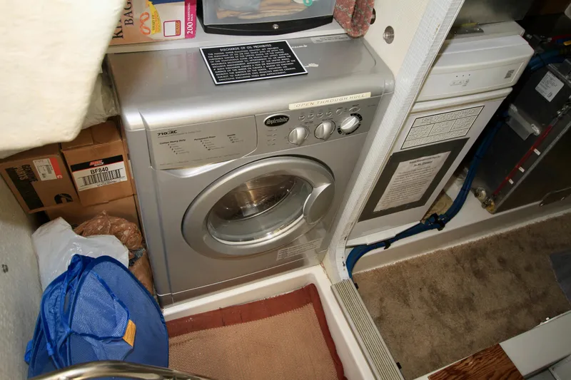 Slide: The Image of Laundry area in a 2011 Fathom Element 43 boat with washer and storage. - 61