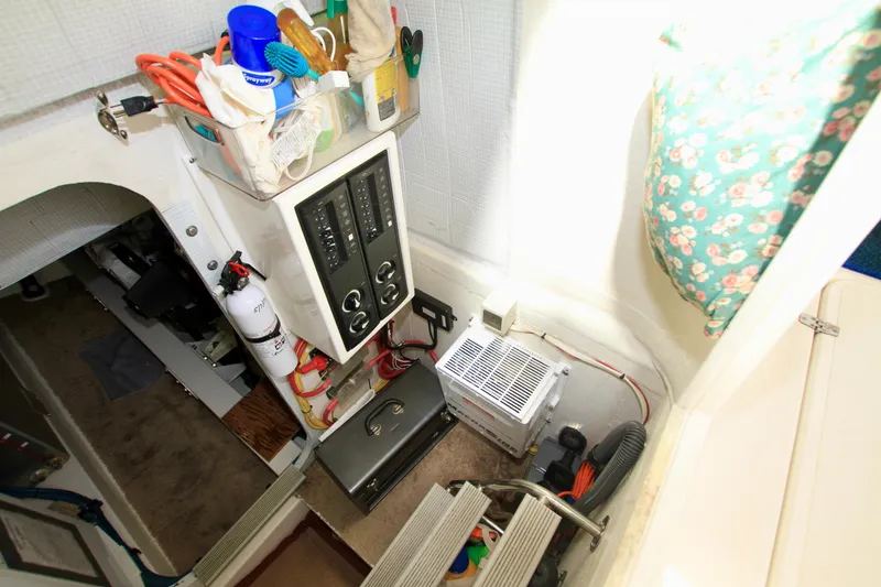 Slide: The Image of Electrical panel and storage area inside a 2011 Fathom Element 43 boat. - 62