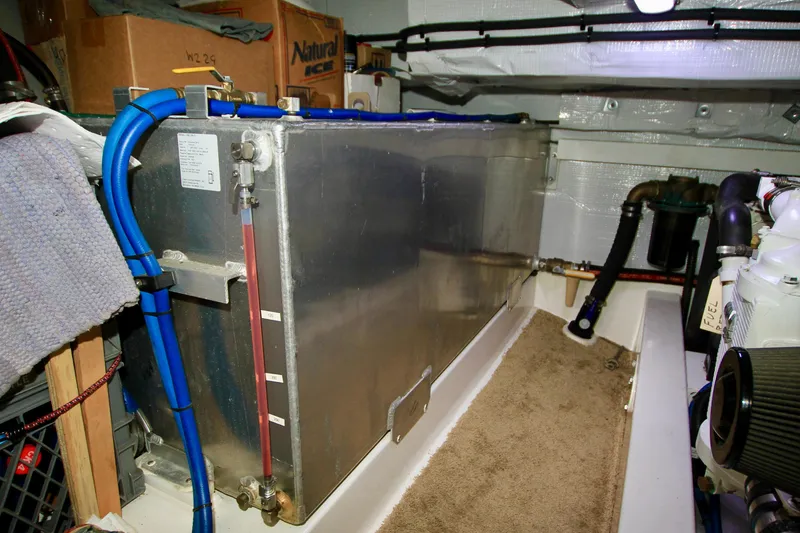 Slide: The Image of Engine compartment of a 2011 Fathom Element 43 with fuel tank and blue hoses. - 64