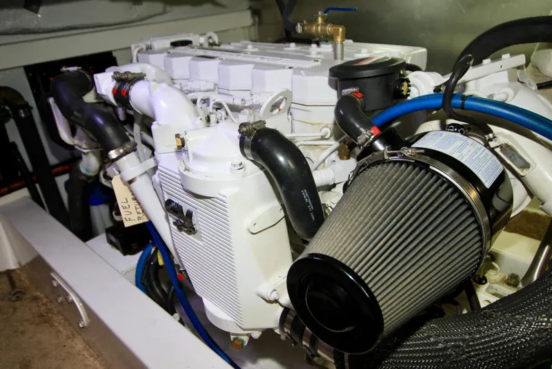 Slide: The Image of Engine compartment of 2011 Fathom Element 43 with visible air filter and hoses. - 66
