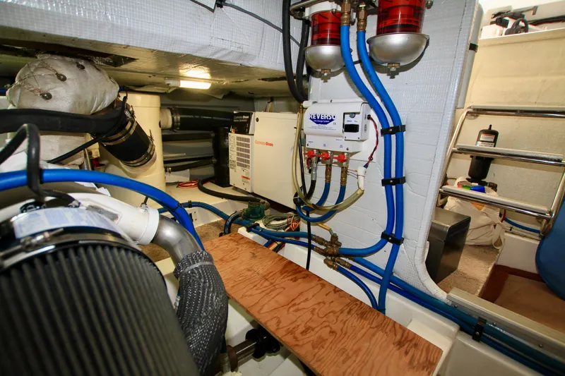 Slide: The Image of Engine room of 2011 Fathom Element 43 with blue hoses and equipment. - 68