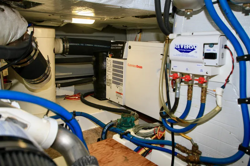 Slide: The Image of Engine room of 2011 Fathom Element 43 with Cummins Onan generator and Reverso oil system. - 69